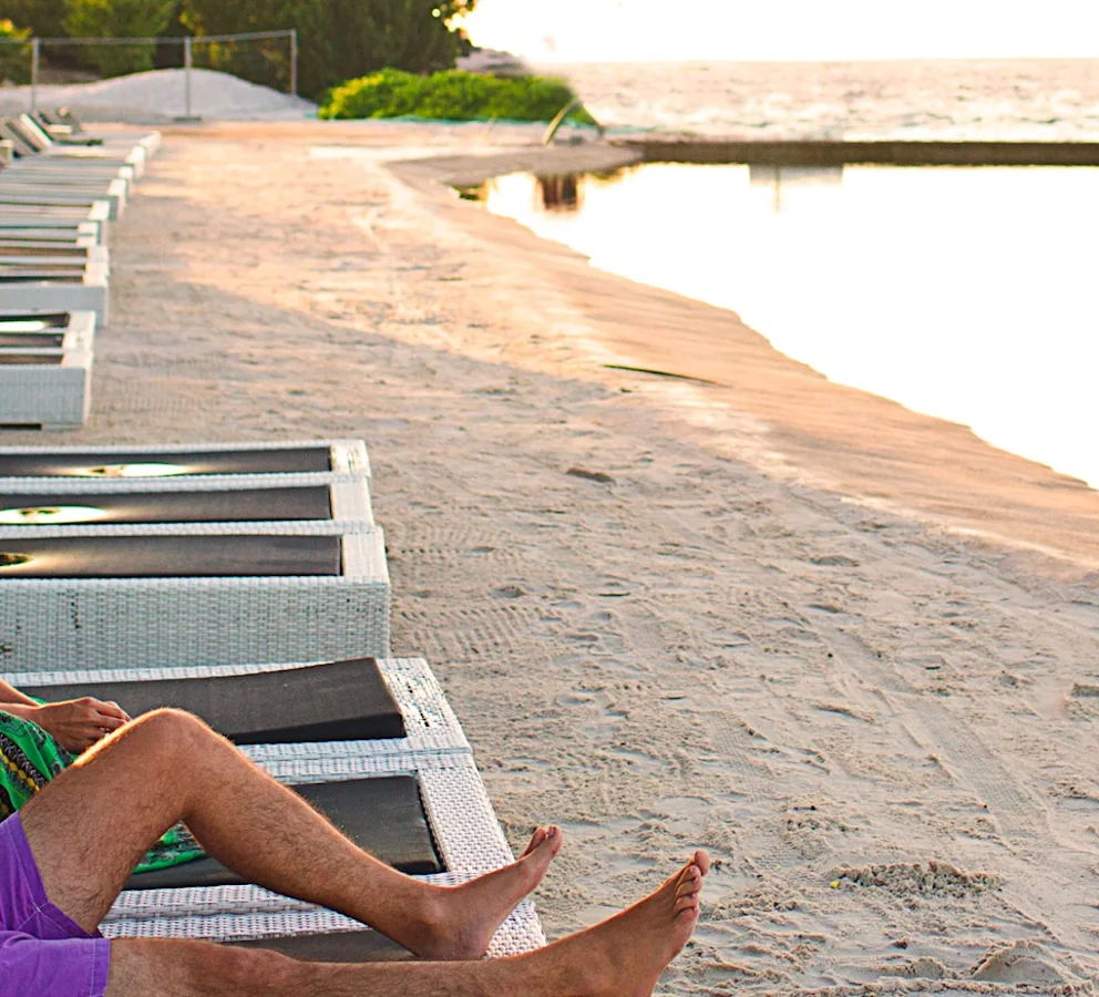 A couple lounging on the beach.