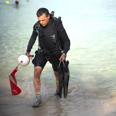 Bryan walking out of the water after diving.