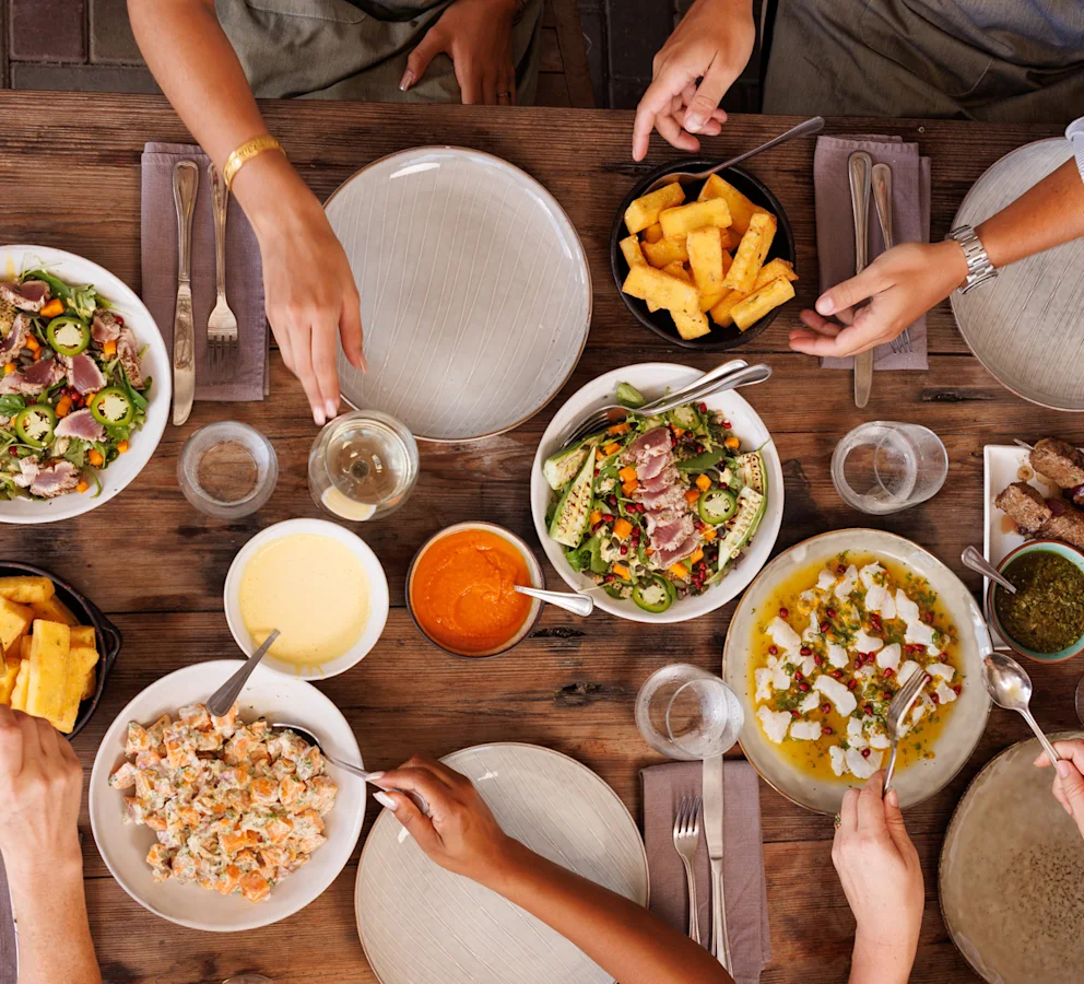 Food on table with hands