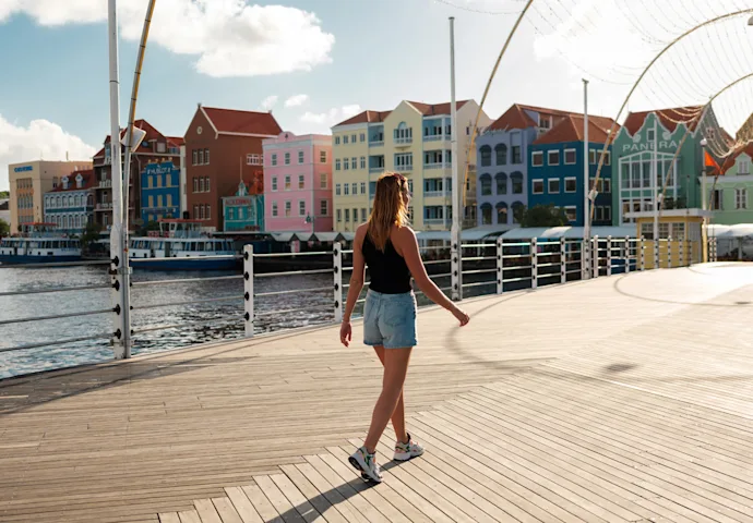 Girl walking on bridge with Handelskade background