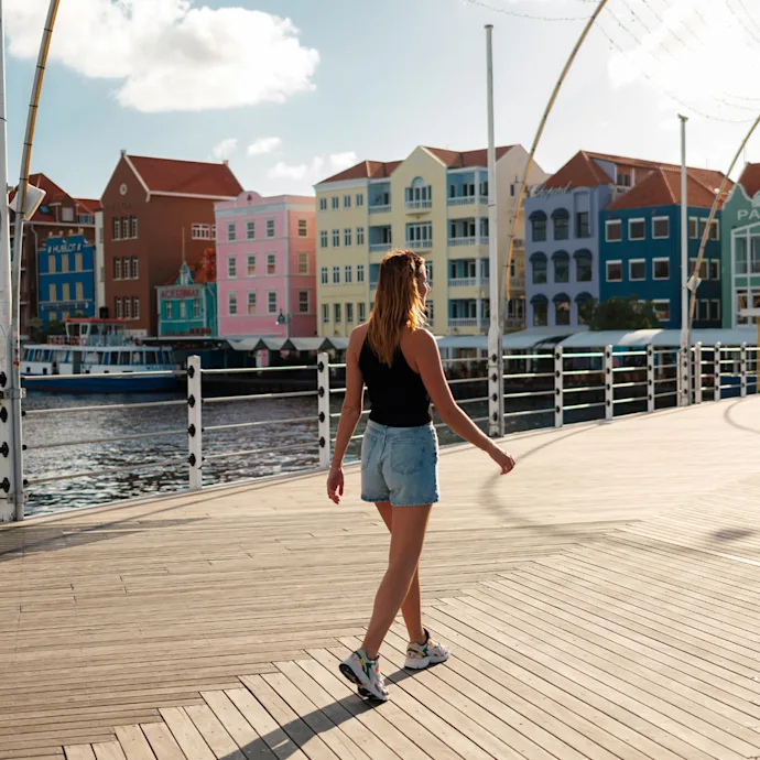 Girl walking on bridge with Handelskade background