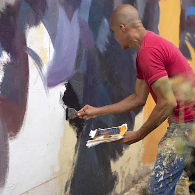Garrick paining a wall