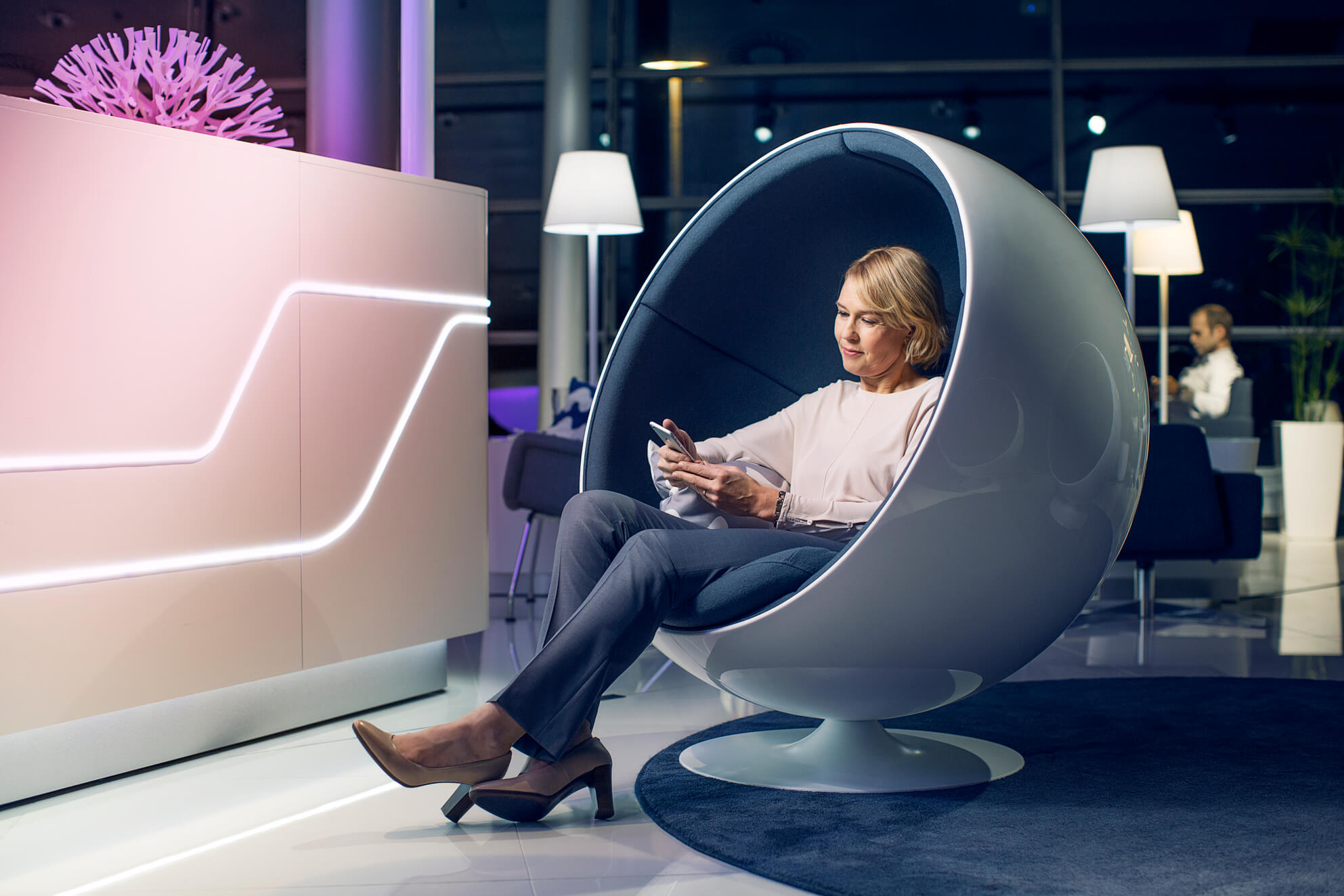 A customers lounges in a ball chair in the Finnair lounge on the Schengen side of Helsinki Airport.
