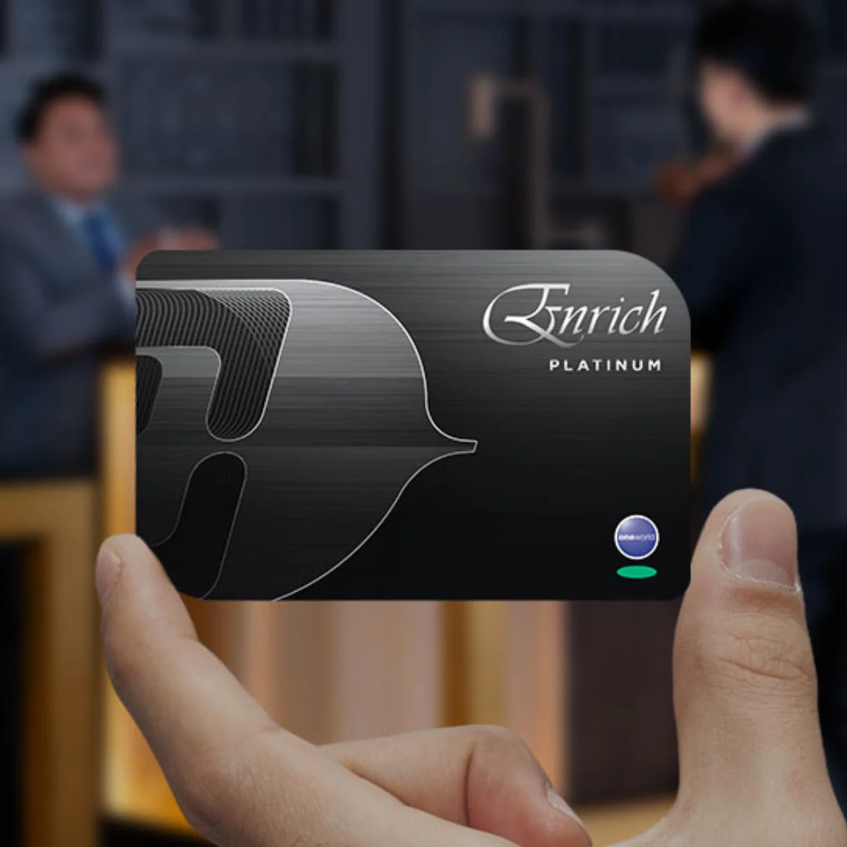 A hand holds up a Malaysia Airlines Enrich Platinum card. 