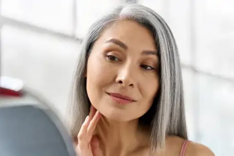 Woman looking at her face