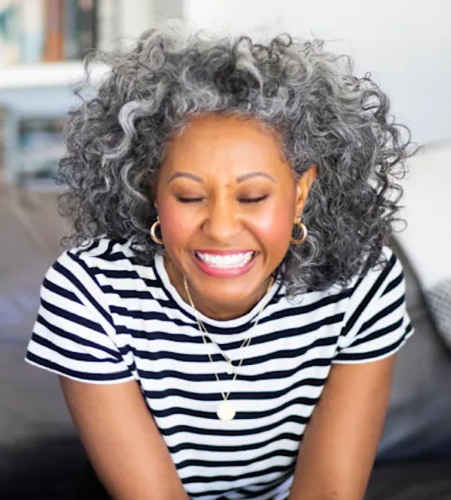 Lady smiling in striped shirt