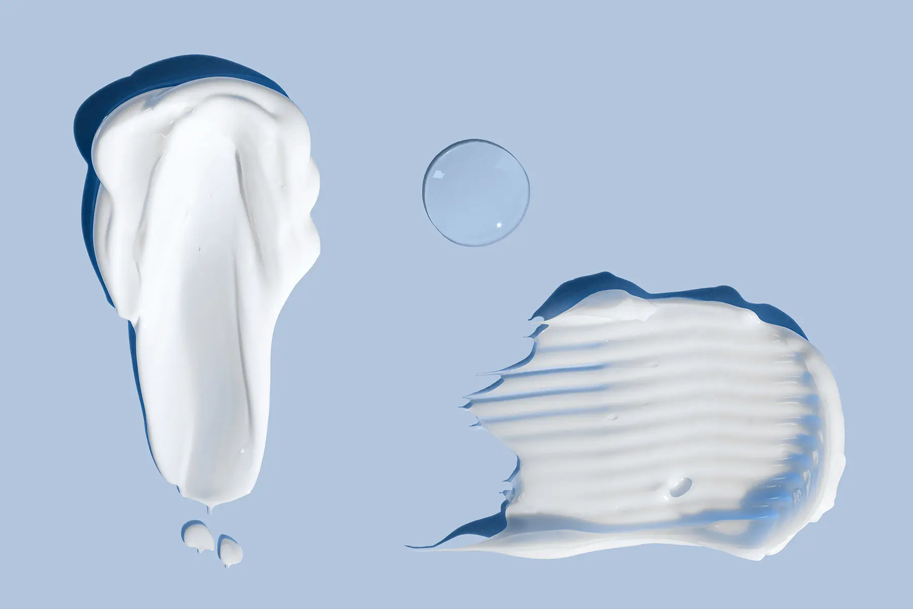 Cream swatches on blue background representing Hydroquinone, Tretinoin and Niacinamide. header