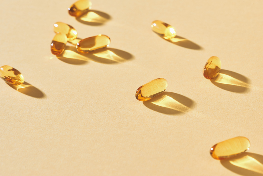 AW218 Your Need-to-Know Remedies for Hot Flashes (photo of vitamin e pills on tan background)