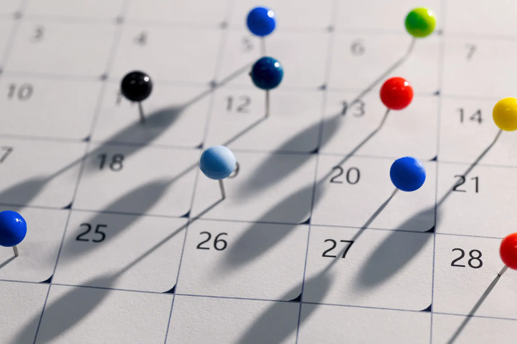 Calendar showing colorful pins marking dates for intimacy. header