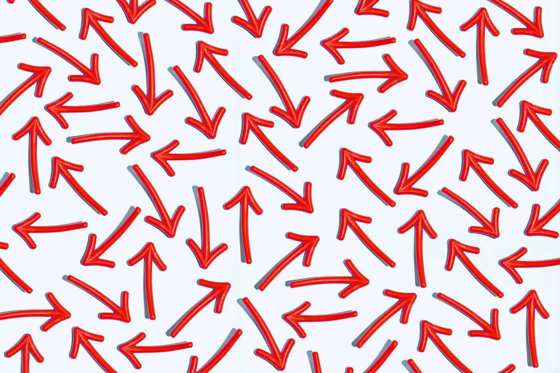 Pale blue background filled with red arrows pointing in a multitude of directions
