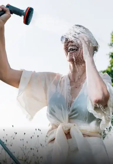 Lady spraying water on herself