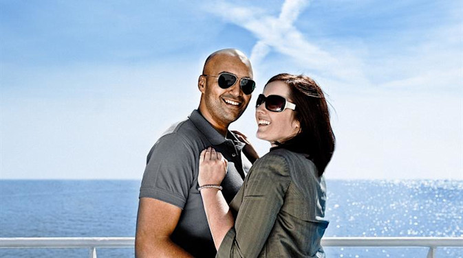 A couple on the top deck of a DFDS passenger ferry on a sunny day
