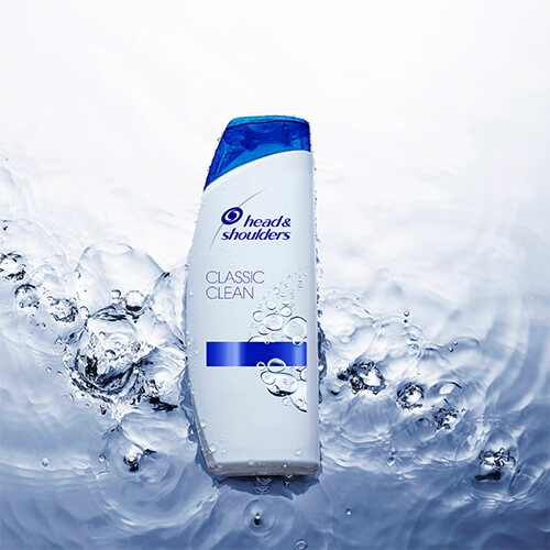 H&S Classic Clean Shampoo bottle lying on the water surface.