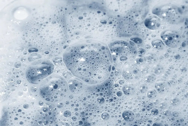 A foam with a big bubbles on the dark blue background.