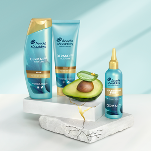 The Repairing Care Collection products standing on crannied surfaces next to slice of cut aloe and a half of avocado