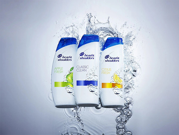Bottles of Apple Fresh shampoo, Classic Clean Shampoo and Citrus Fresh shampoo in the splash of water