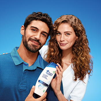 A woman and a man are presenting H&S Classic Clean shampoo.