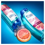 two lying bottles of Deep Cleanse Gentle Purification H&S Shampoo and, between them, a slice of grapefruit