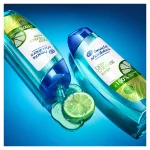 two lying bottles of Deep Cleanse Oil Control  H&S Shampoo and, between them, a slice of lemon