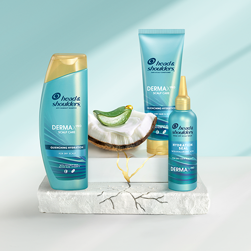 The Quenching Hydration Collection products standing on crannied surfaces next to slice of cut aloe and a piecie of coconut