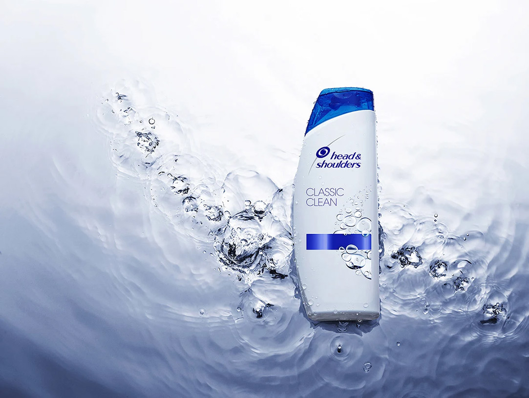 Head & Shoulders Classic Clean bottle lying on the water surface.