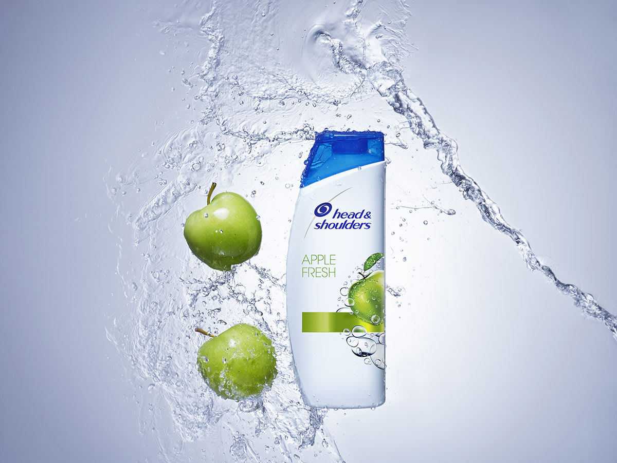 Head and Shoulders Apple Fresh shampoo bottle composed with fresh green apples and a splash of water