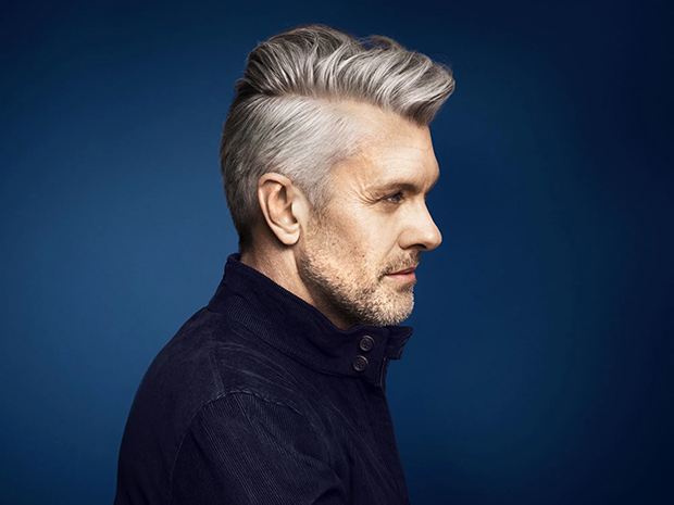 Older man with grey, long quiff