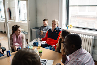 group of people happy around conference table
