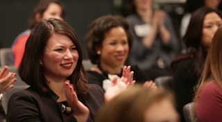 women in audience clapping