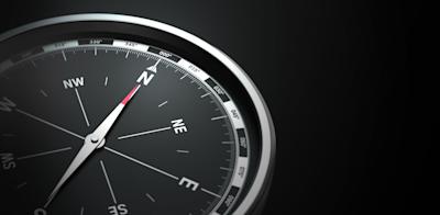compass on black background, benefits of okrs, pointing north