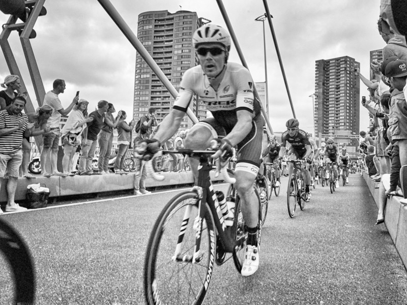 Black and White Photo of cyclist in Tour de France peleton crossing bridge in Rotterdam.