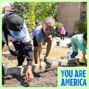 An adult and 2 children planting seeds in a garden