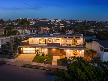 Exterior photo of Pacific Shoes at night with all the light illuminated.