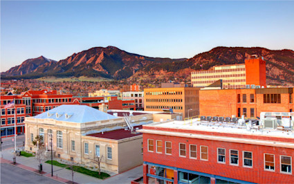 Boulder glows at sunset with red brick streets and the Flatirons beyond, a must-see among the most beautiful places in the US.