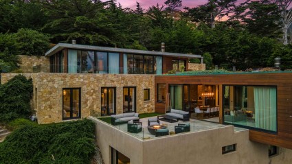 A modern hillside home in Carmel with cantilevered spaces, a patio and indoor-outdoor living