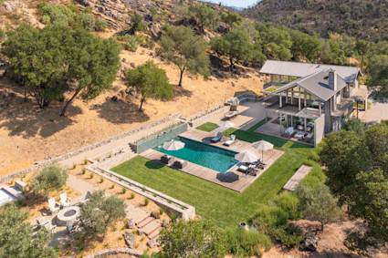 Aerial view of a home with a large backyard and pool