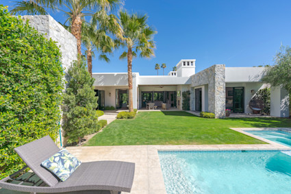 Palm Springs backyard with pool, grass, and outdoor seating