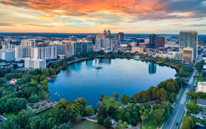 The city of Orlando is visible behind a line of palm trees, one of the best spring break ideas for families.