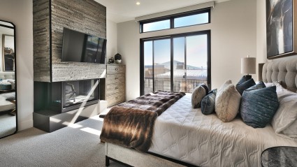 Bedroom with fireplace and balcony