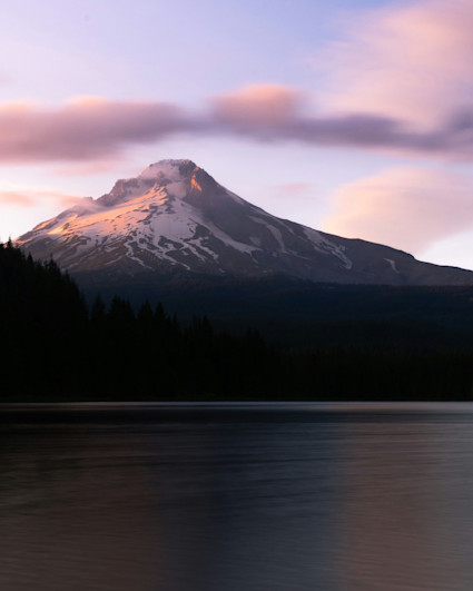 View of Hood mountain as seen from a lake with purple sunset.