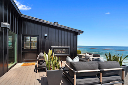 black malibu house overlooking ocean