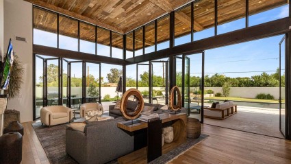 Living room of a Scottsdale second home with dramatic floor-to-ceiling windows and high ceilings and modern decor