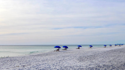 Beach chairs and umbrellas line the beach at Seagrove Beach, one of the best beaches for kids in the South.