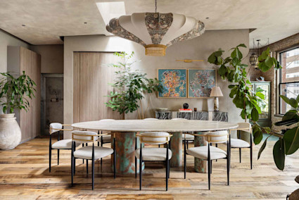 Contemporary dining room with abstract art and large foliage in Infinity by Pacaso home in New York, NY.
