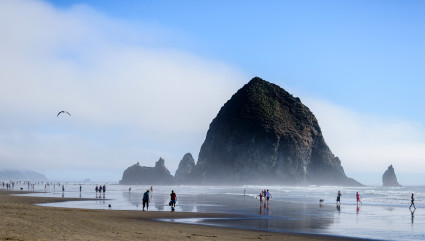 Haystack Rock rests off the shore of Cannon Beach, one of the best beaches for kids on the West Coast.