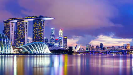 The skyline of Singapore is visible from the water, one of the best vacation spots for couples. 