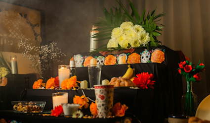 Ofrenda or alter with traditional decorations like flowers and candles.