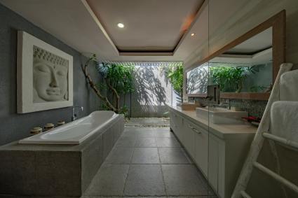 Spa bathroom with large tub and windows looking at trees