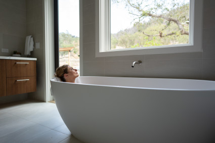 Woman enjoying a relaxing bath in a soaking tub