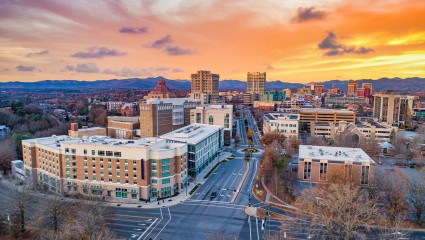 An aerial photo captures the cityscape of Asheville, North Carolina, one of the best destinations for pet-friendly vacations.